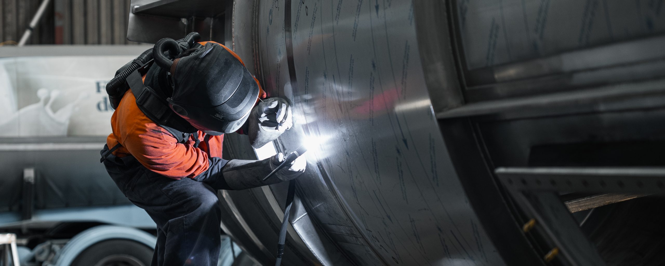 A fabricator works on a stainless steel tank in Longveld's Hamilton workshop