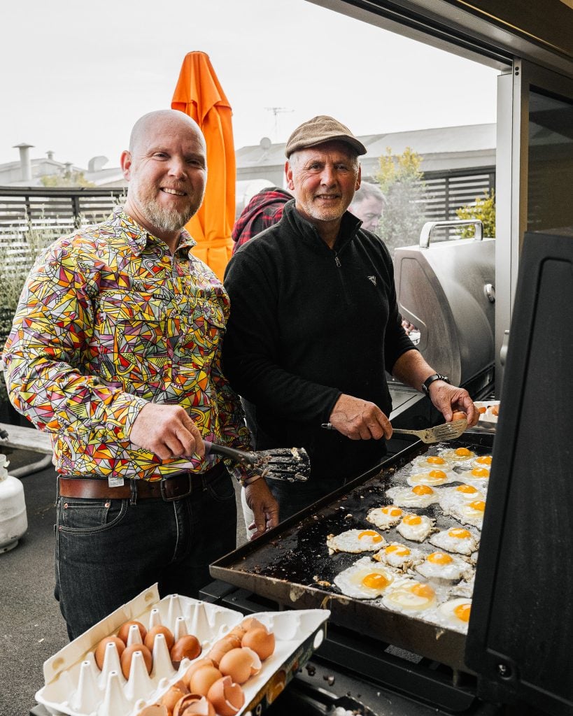 James Rhynes and Les Roa cook the team breakfast